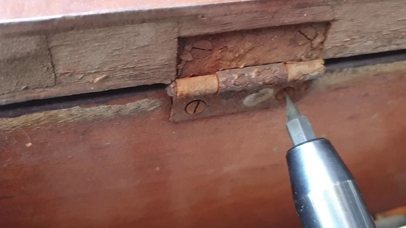 Technician servicing a worn meter box hinge in Perth